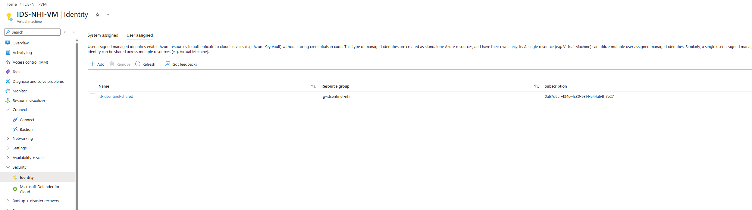 IDS-NHI-VM Identity blade — both system-assigned and user-assigned identities active
